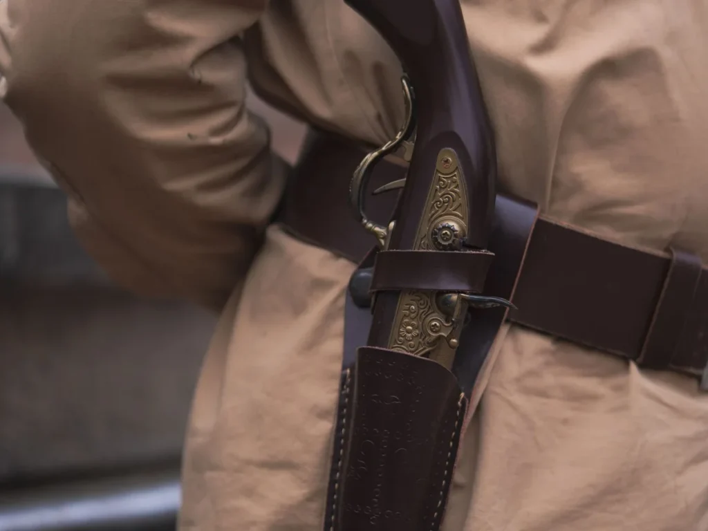 Close-up of a handgun secured in a belt holster
