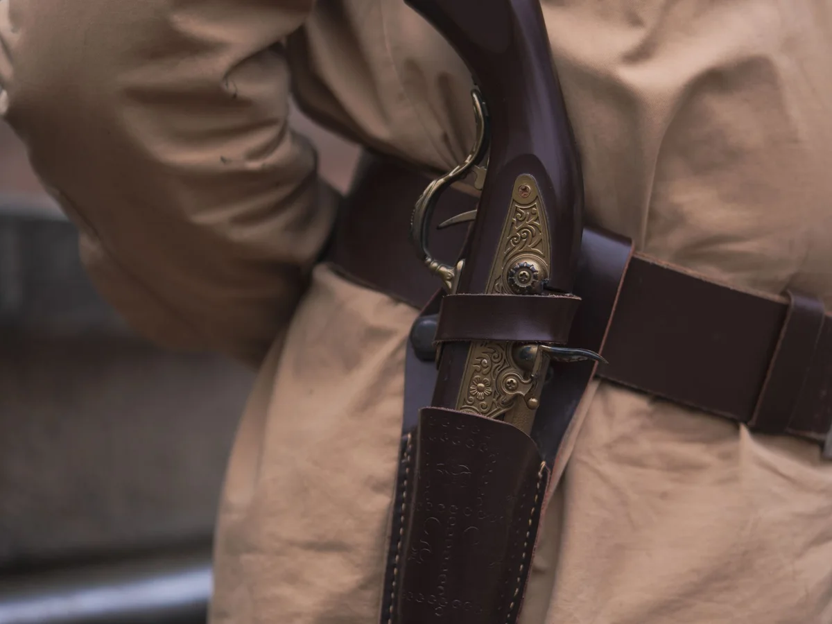 Close-up of a handgun secured in a belt holster