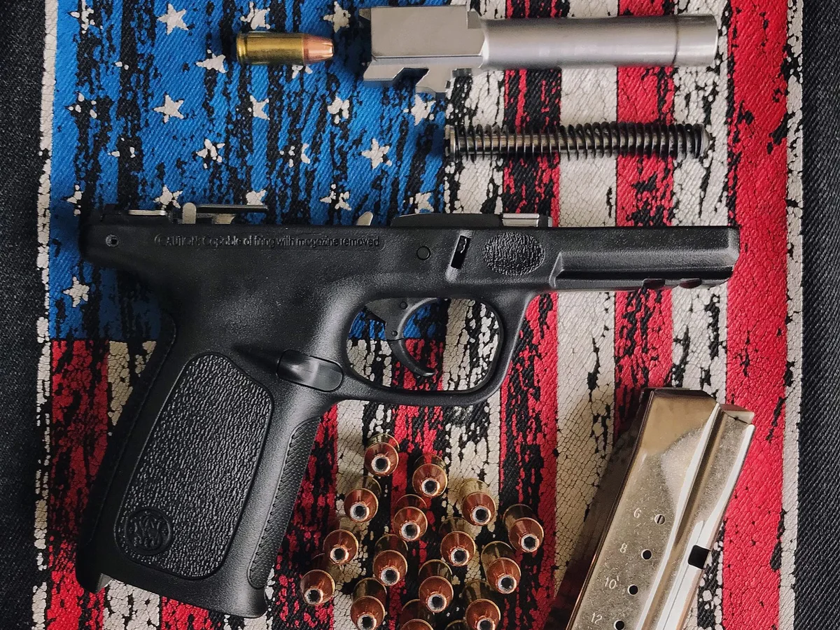 Disassembled handgun components and ammunition