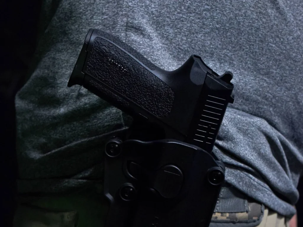 Handgun secured in a close-fitting belt holster