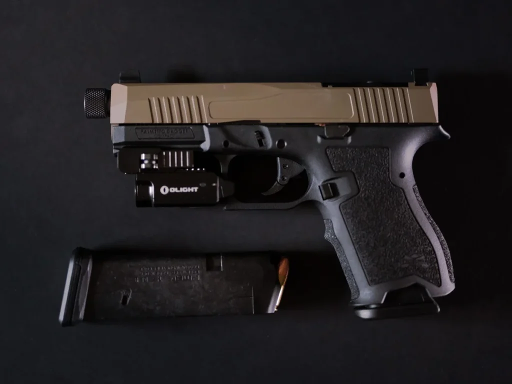 Detailed handgun and magazine against a dark background