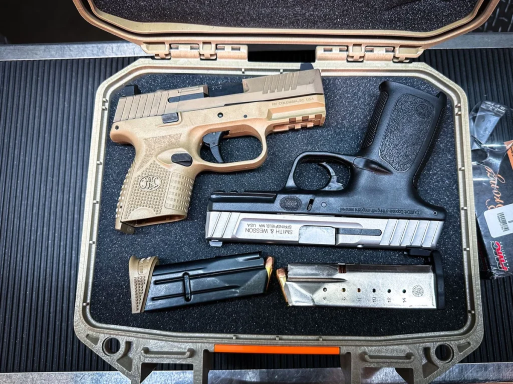 Handguns and magazines arranged in a protective case