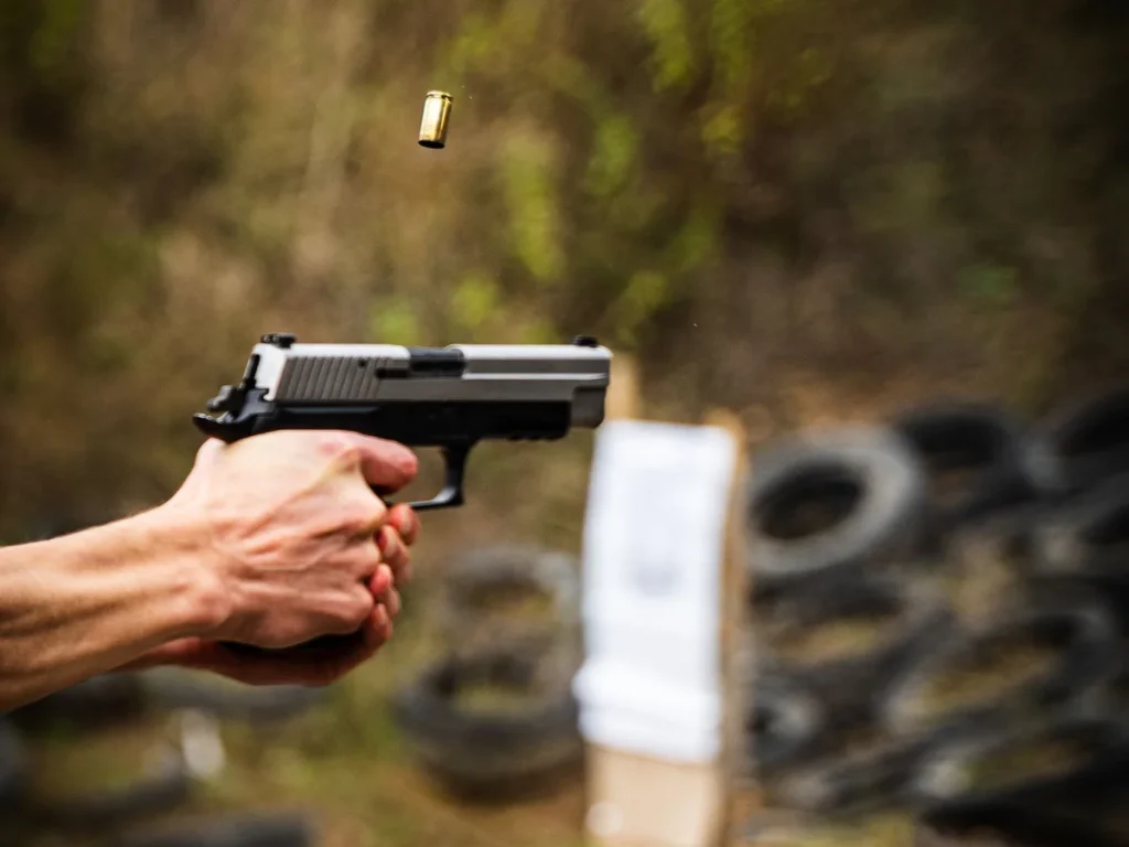 Close-up of handgun practice at an outdoor shooting range