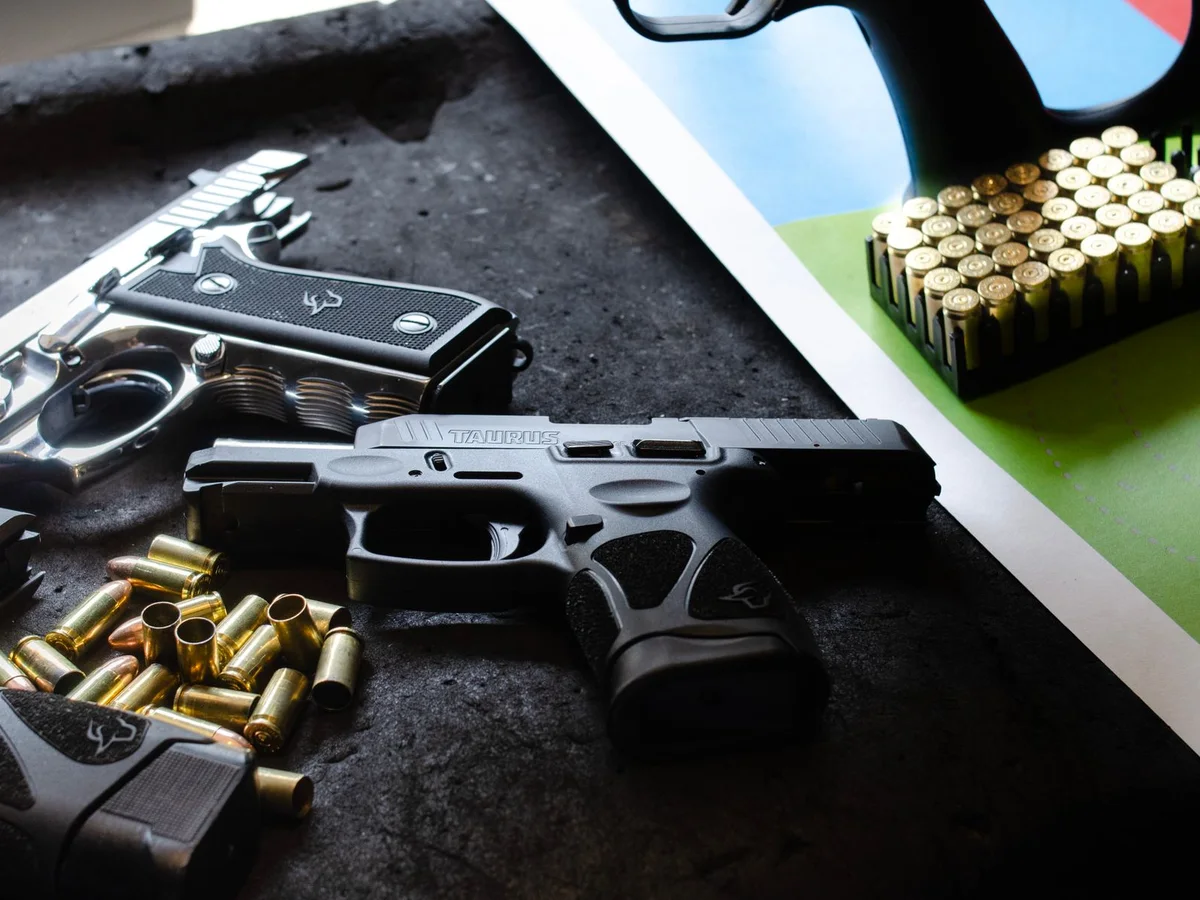 Modern handguns, magazines, and ammunition on display