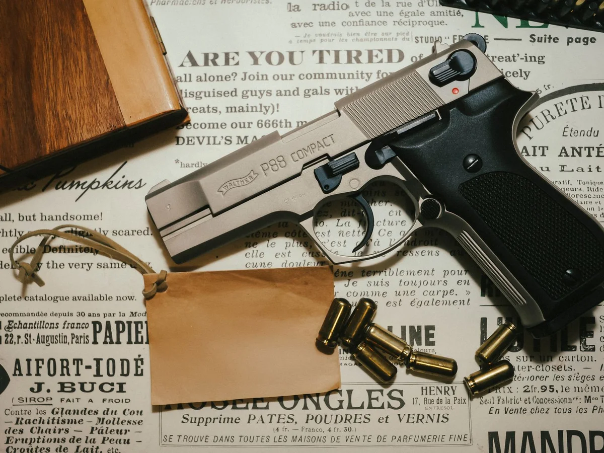 Compact handgun, magazine, and cartridges displayed together