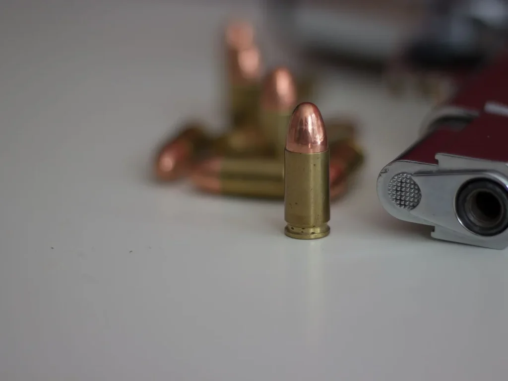 Detailed close-up of a handgun and cartridges