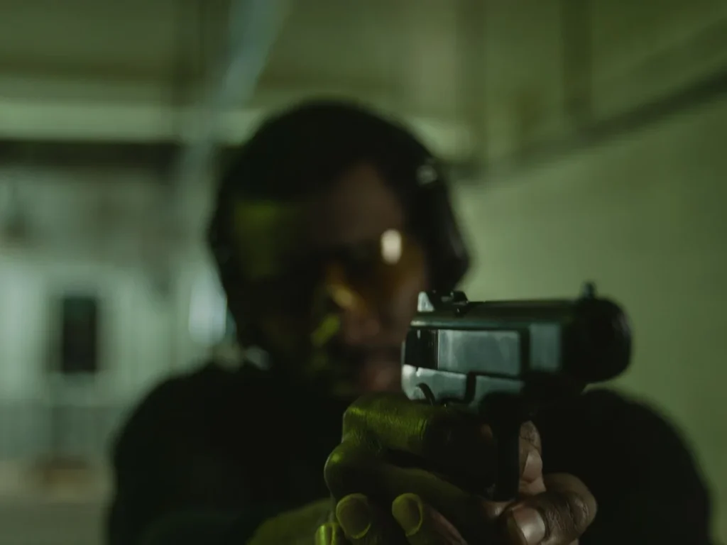 Handgun shooter using eye and hearing protection at a range