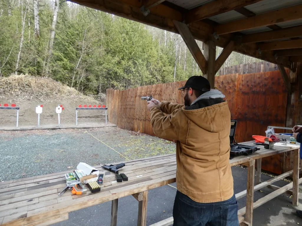 Outdoor handgun range practice with safety gear and targets