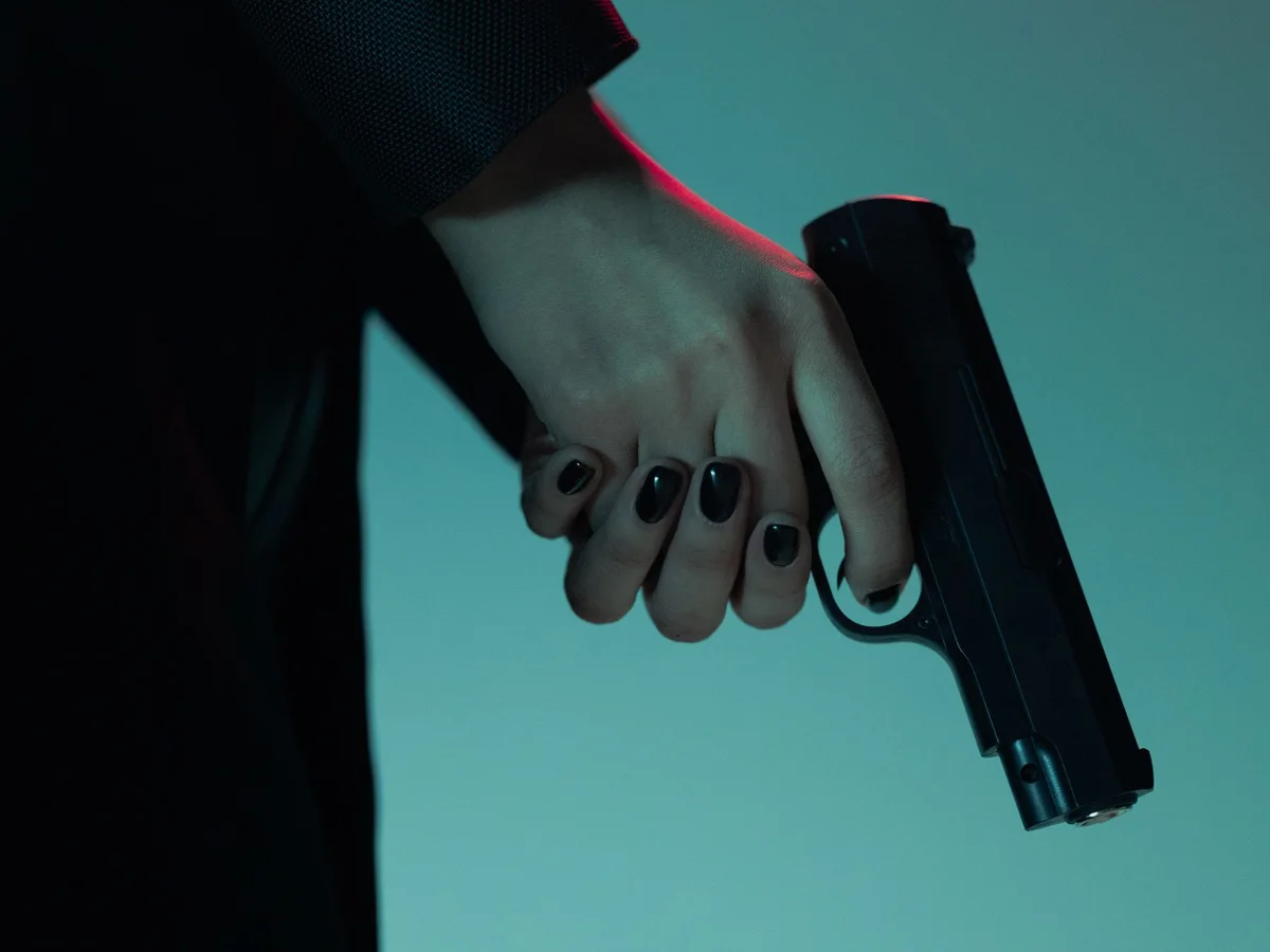 Close-up of a handgun grip under dramatic studio lighting
