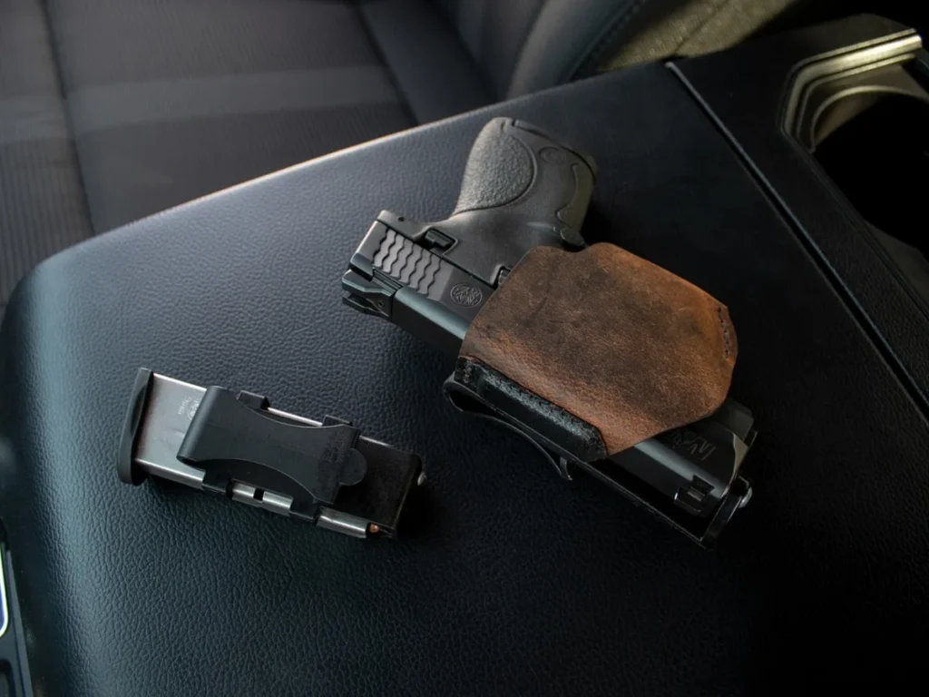 Handgun and detached magazine on a dark surface